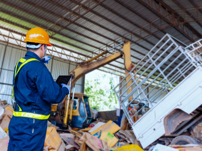 Man in hard hat overseeing crane operation