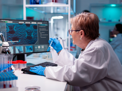Woman sitting at table with monitor performing a chemical test