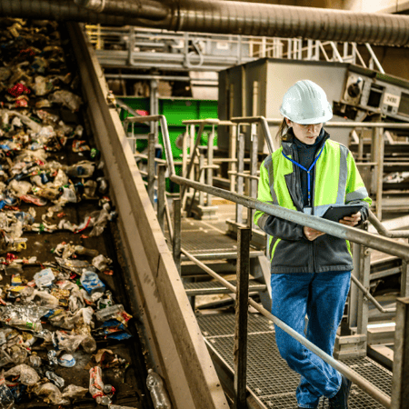 woman reviewing waste conveyor