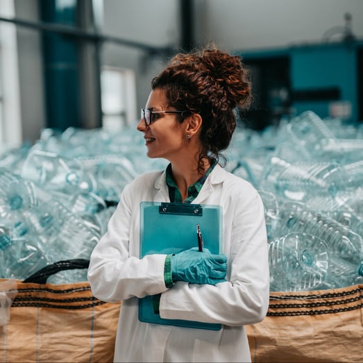 a plastic waste manager holding a clipboard