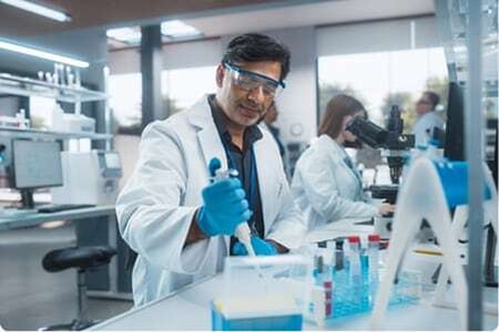 Technicians in pharmaceutical lab conducting experiments