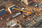 Crane works at construction site.