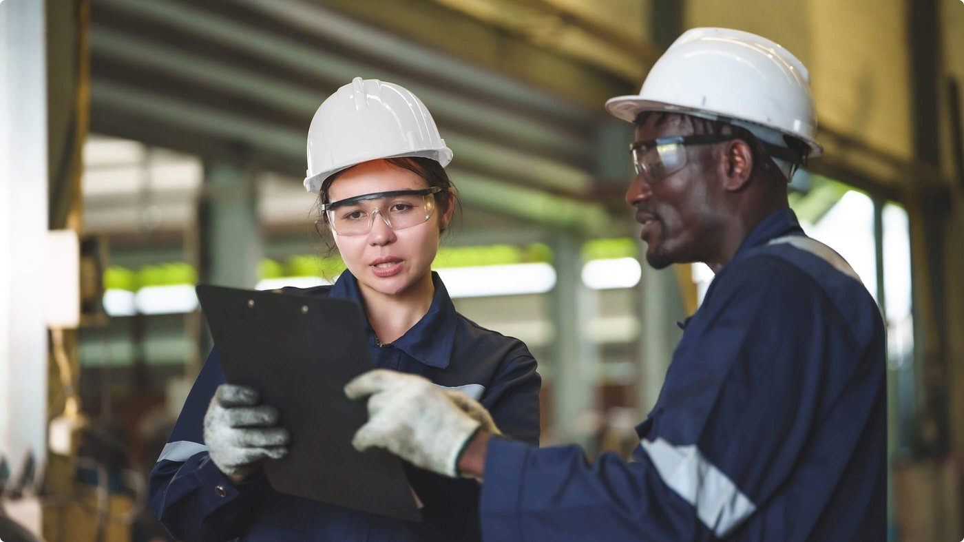 Two workers review data on tablet