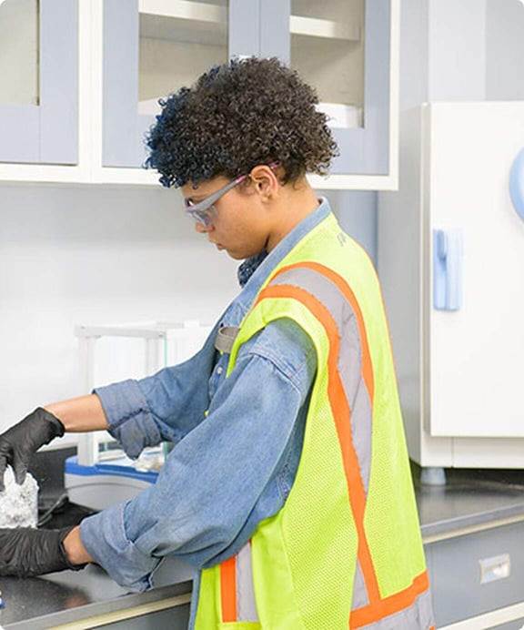 Reworld employee tests alt fuel material in laboratory