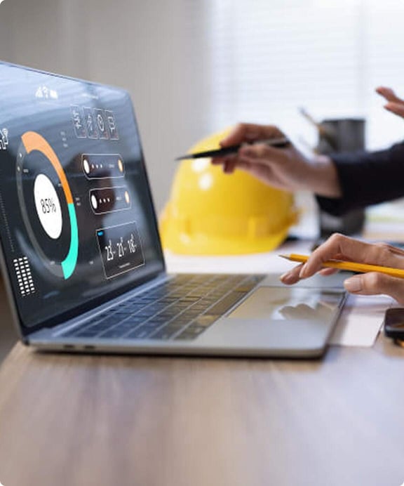 Looking at business logistics data on a laptop.