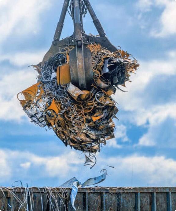 Grapple with a load of waste for waste-to-energy production at a thermomechanical treatment facility.