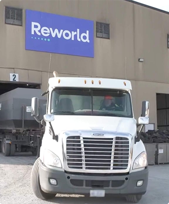 Reworld truck leaves facility to pickup items for secure disposal.