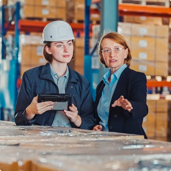 Retail workers review waste material.