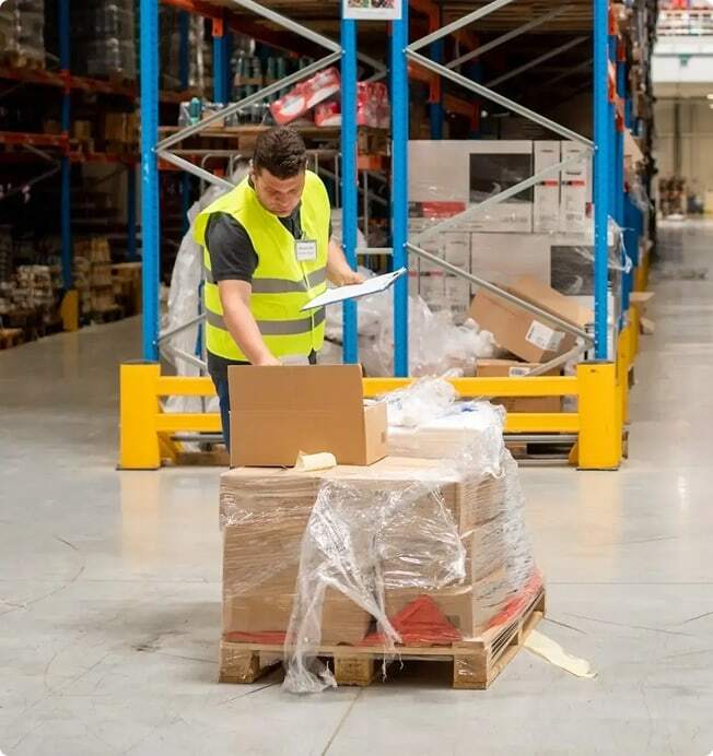 Retail worker arranges waste for pickup.