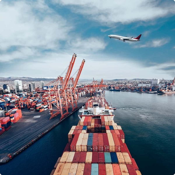 Transportation industry scene, airplane flies above shipping port.