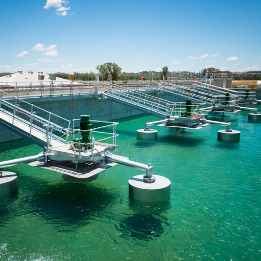 wastewater treatment tank with clear, teal water