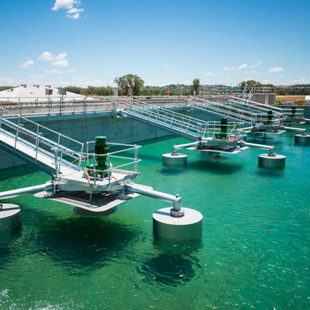 wastewater treatment tank with clear, teal water
