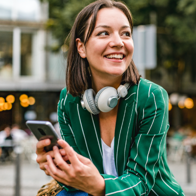woman in a green shirt with a phone