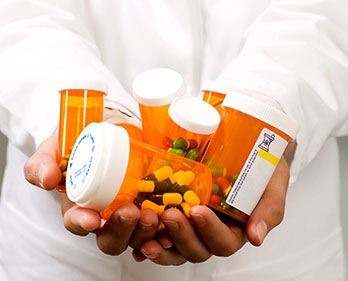 Orange prescription bottles with blue and red pills
