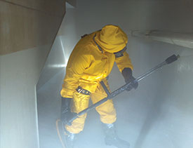 a Covanta Environmental Solutions employee cleaning a frac tank