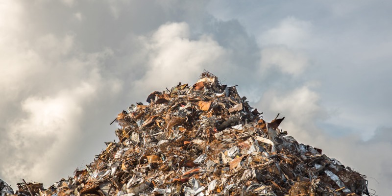 A mound of garbage before a cloudy sky