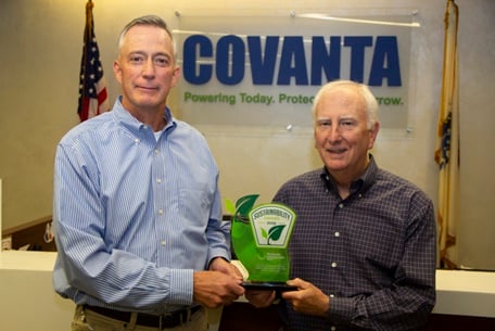 Paul Stauder, President of Covanta Environmental Solutions, above left, holding the award with Chief Sustainability Officer Paul Gilman
