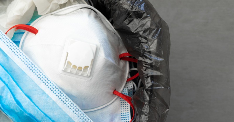 personal protective equipment in the trash